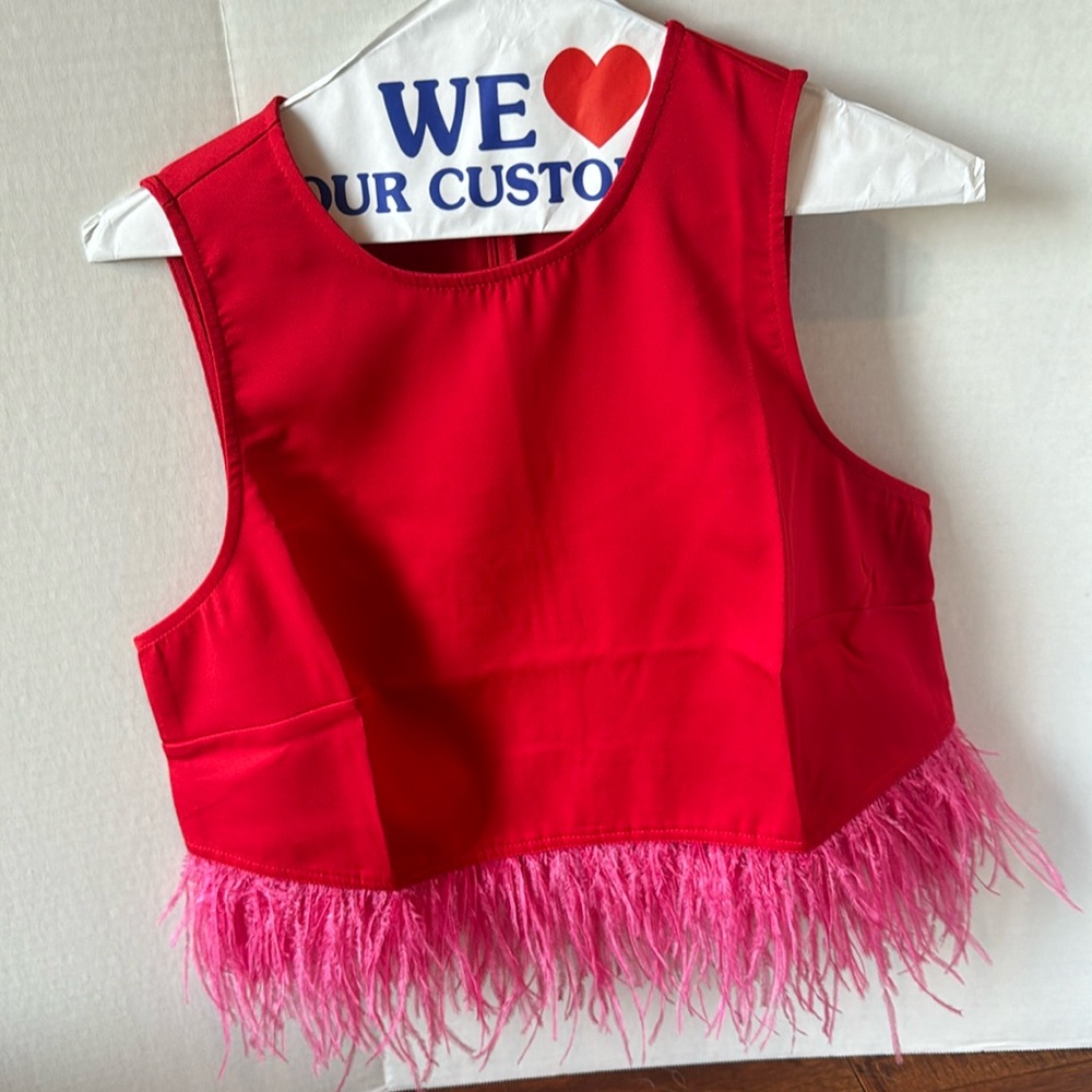 Bright red blouse with pink feather trim